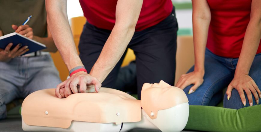 young-male-practicing-cpr-first-aid-on-mannequin-in-the-presence-of-people-scaled[1].jpg